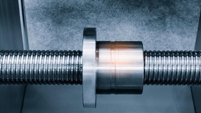 Close up of industrial metal screw shaft as part of screw transmission. tech industrial technology background
