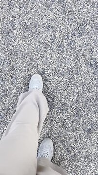 Vertical POV video of a person walking on asphalt in casual sneakers. Ideal for lifestyle ads, fitness content, travel reels, and social media stories.