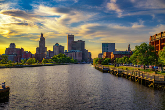 Golden sunset over the Providence River with downtown Providence skyline and waterfront park in Rhode Island, USA.