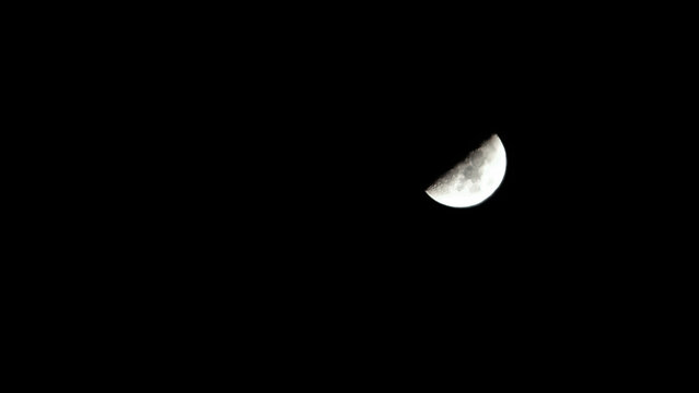 landscape view of the half moon in the dark night sky