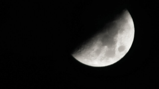 landscape view of the half moon in the dark night sky
