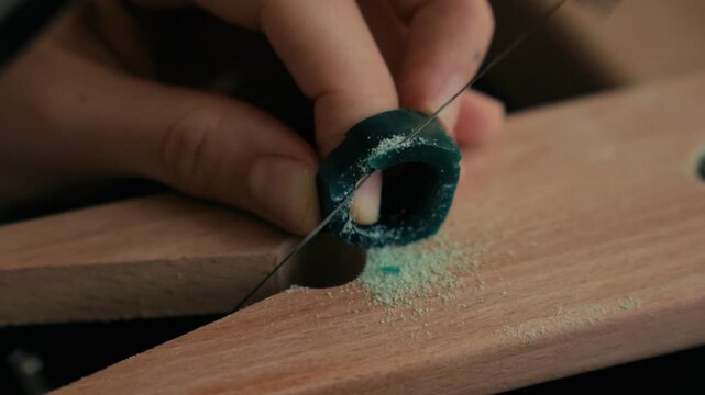 Static Macro Video of Jeweler Cutting Green Wax Signet Ring with Piercing Saw on Bench Pin