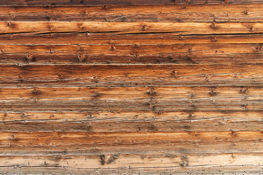 Guttannen, Switzerland. Weathered wooden chalet wall texture with natural timber grain background