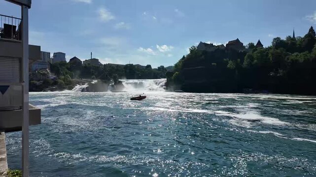 Scenic view of Rhine Falls in Switzerland with tourist boats and Laufen Castle: 