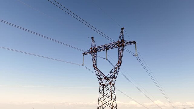 Metal electricity pylon in agricultural field, high voltage power line transmission and energy infrastructure concept