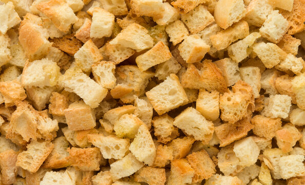 Croutons close up, crispy bread cubes, dry rye crumbs top view