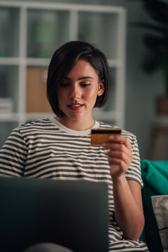 Woman shopping online with laptop and credit card, making secure payment for e commerce purchase