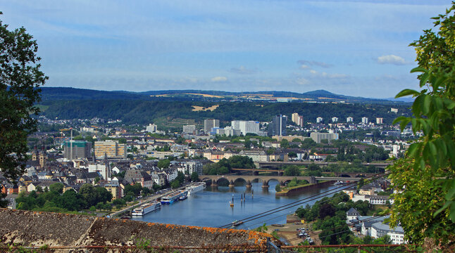 Panoramic view from the hilltop in Koblenz overlooking the Moselle and Rhine Rivers, with the Baldwin bridge and cruise ships docked in the distance