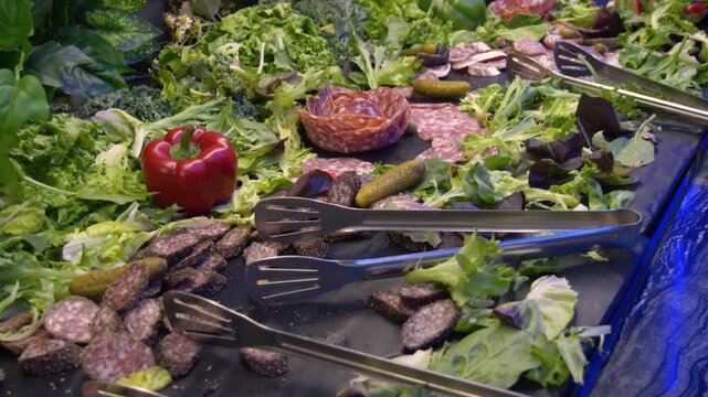 Cold cuts buffet with salami and fresh vegetables