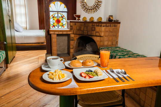 Healthy Breakfast Spread on Wooden Table in Cozy Cabin Kitchenette with Scrambled Eggs, Fruit, and Coffee