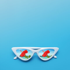 Obraz premium Sunglasses reflecting hibiscus flower by sea on light blue background. Space for text