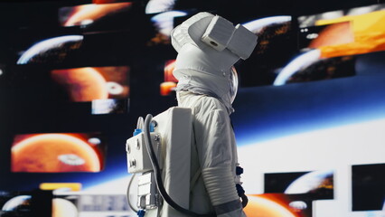 Astronaut in a spacesuit floats in orbit above Earth, symbolizing humanity’s journey into space and the pursuit of discovery, technology, exploration, and the unknown universe during a space mission. © DC Studio