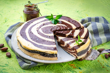 Obraz premium artisan homemade baked zebra black-white cheesecake pie with dark chocolate