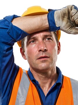 Exhausted construction worker wiping sweat from forehead, tired manual laborer in hard hat and safety vest, overworked industrial employee