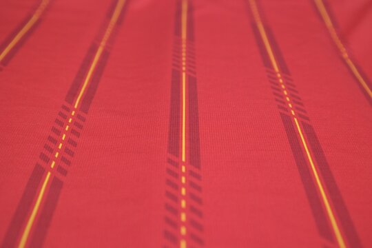 Spain-inspired football jersey texture with red tones and red-yellow stripes, designed for a dynamic sporty look.