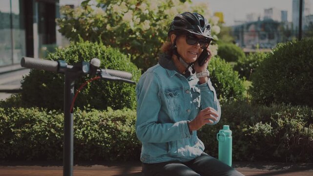 Embracing modern technology for daily life. An electric scooter parked by a park bench represents a smart, sustainable choice for seniors seeking flexible and environmental-friendly mobility.