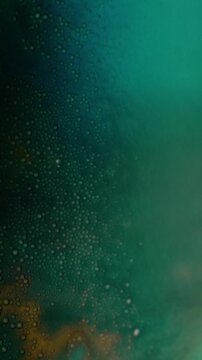 Dynamic colored liquid with bubbles as abstract background. High quality 4k footage