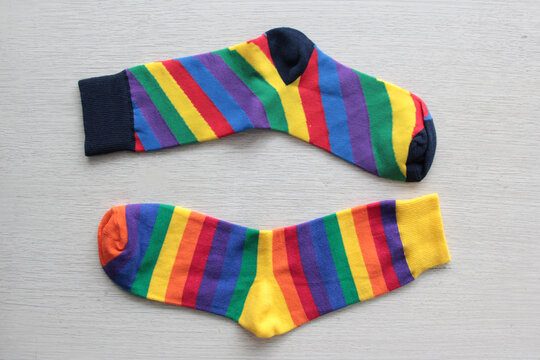 Colorful, mismatched socks ready to be worn as a symbol of inclusion, diversity, and acceptance to promote respect for people with Down syndrome