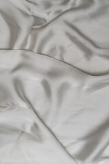 Fototapeta premium Elegant white satin cloth with folds