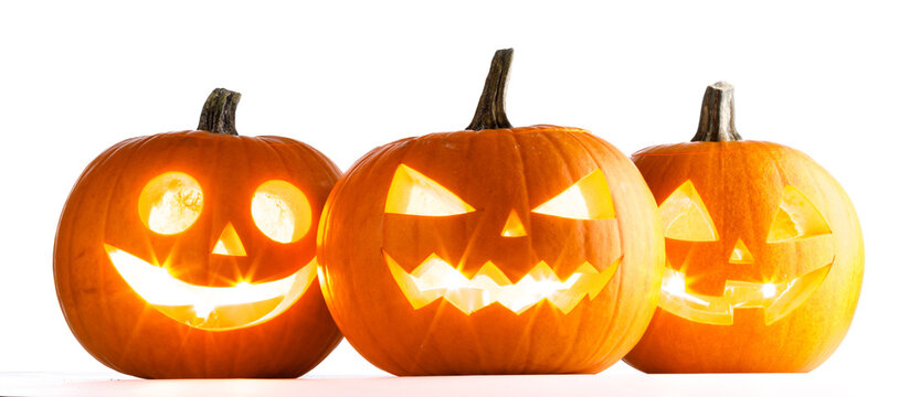 Carved Halloween pumpkins with scary faces illuminated from inside