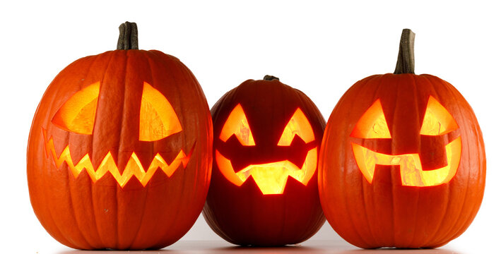 Carved Halloween pumpkins with scary faces illuminated from inside
