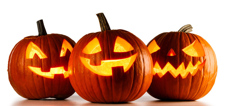 Carved Halloween pumpkins with scary faces illuminated from inside