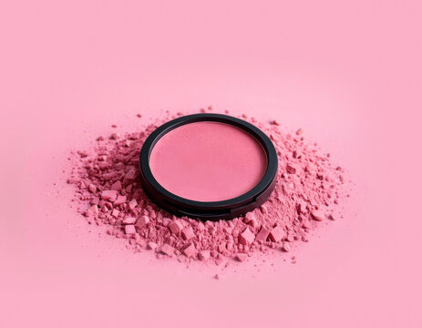 Bright pink blush for the face. A compressed cosmetic product. A crumbly cosmetic product. Transformation. Beauty.