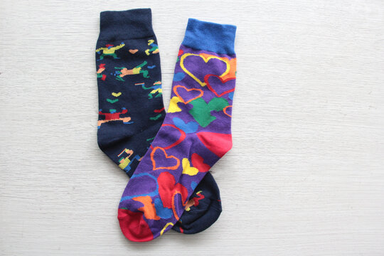 Colorful, mismatched socks ready to be worn as a symbol of inclusion, diversity, and acceptance to promote respect for people with Down syndrome
