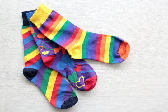 Colorful, mismatched socks ready to be worn as a symbol of inclusion, diversity, and acceptance to promote respect for people with Down syndrome