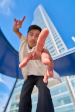Young man reaching out in urban city setting