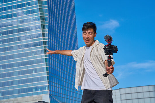Male vlogger creating content with camera urban city