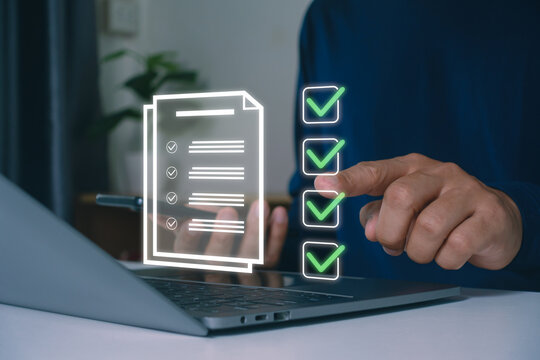 Businessman using laptop for online checklist survey, filling out digital form checklist. take assessment, questionnaire, evaluation, online survey, online exam. Business performance checklist concept