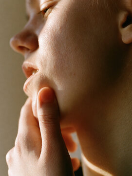 Jaw pain relief jaw clenching face massage chin massage lower face side view close up human skin finger thumb hand oral pain facial pain jawline cheek mouth lip ear neck portrait person natural