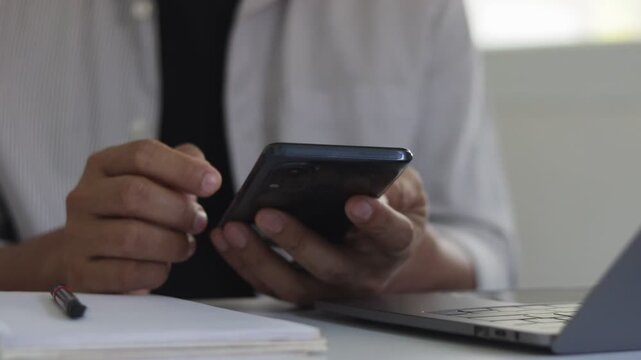 Close-up of a person using a smartphone for mobile banking, digital payment, online shopping, financial management, fintech services, secure transactions and modern cashless lifestyle technology.