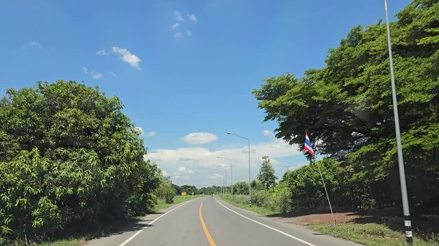 Driving on country road in rural, Singburi province Thailand.