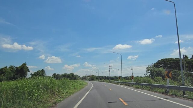 Driving on country road in rural, Singburi province Thailand.