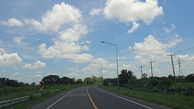Driving on country road in rural, Singburi province Thailand.