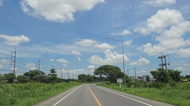Driving on country road in rural, Singburi province Thailand.