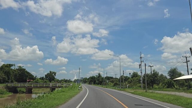 Driving on country road in rural, Singburi province Thailand.