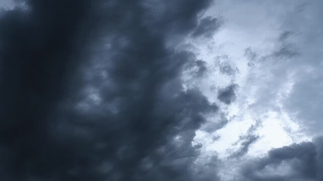 Time-lapse of storm clouds drifting across an evening sky at blue hour
