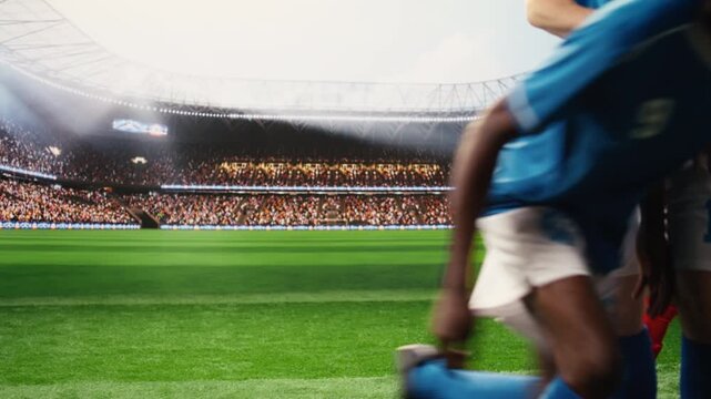 Footballer shooting free kick and running forward with soccer ball in possession, breaking away from defender wall with agility and pace.