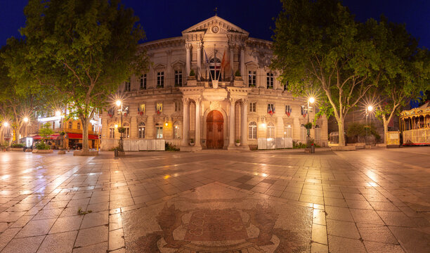 Night view of Hotel de Ville on Place de l'Horloge illuminated in the historic center of Avignon, Provence, France.