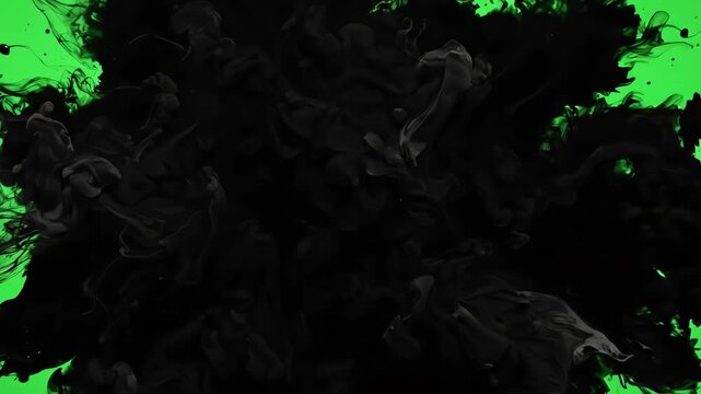 Cinematic organic black ink spreading across a bright green screen background creating a fluid motion transition for video editing