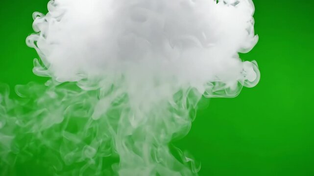 Cinematic thick white smoke rising and swirling slowly against a bright green screen background for visual effects compositing