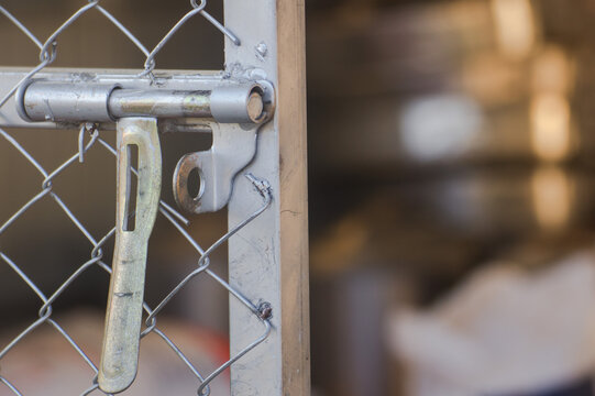 Close up of a rustic wooden door with metal lock