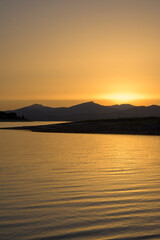 Golden sunset over mountain reservoir © MiguelA