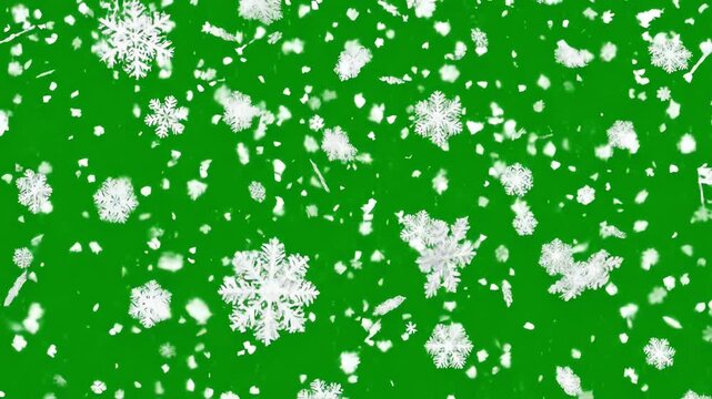 Detailed white snowflakes falling slowly against a bright green screen background for easy chroma keying and winter overlay composition