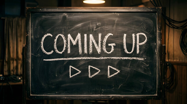 Chalkboard sign displaying coming up text and play buttons indicating future schedule information with geometric symbols indicating indicating upcoming events