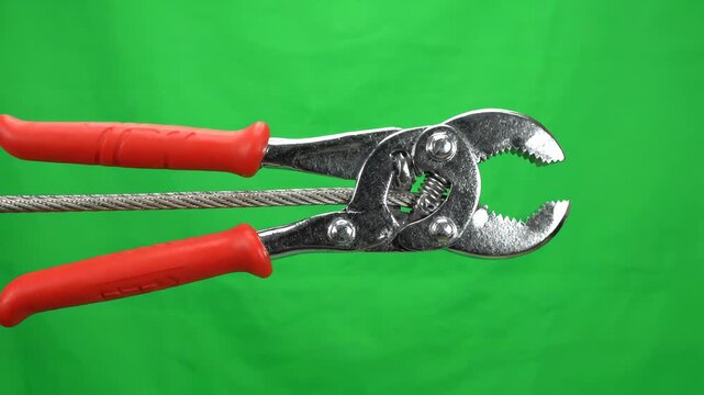 Flexible long reach hose clamp tool opening and closing against a bright green screen background for easy keying and video editing