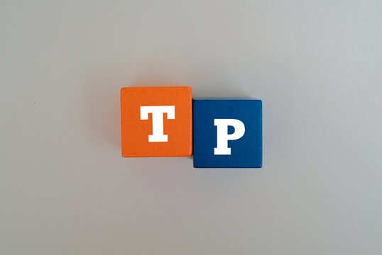 Colorful blocks with the text TP. TP acronym for "TRANSFER PRICING". Representing Transfer Pricing in corporate tax, accounting, and finance concepts